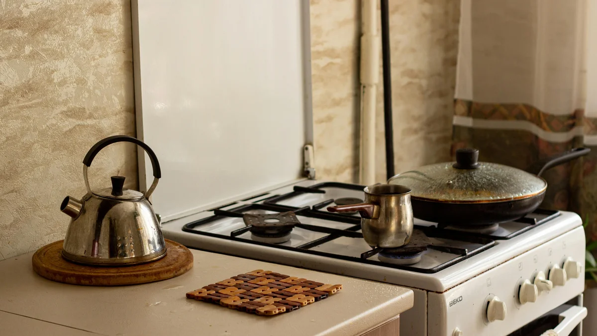 A traditional kitchen stove with a kettle and pan, creating a warm, homey ambiance.