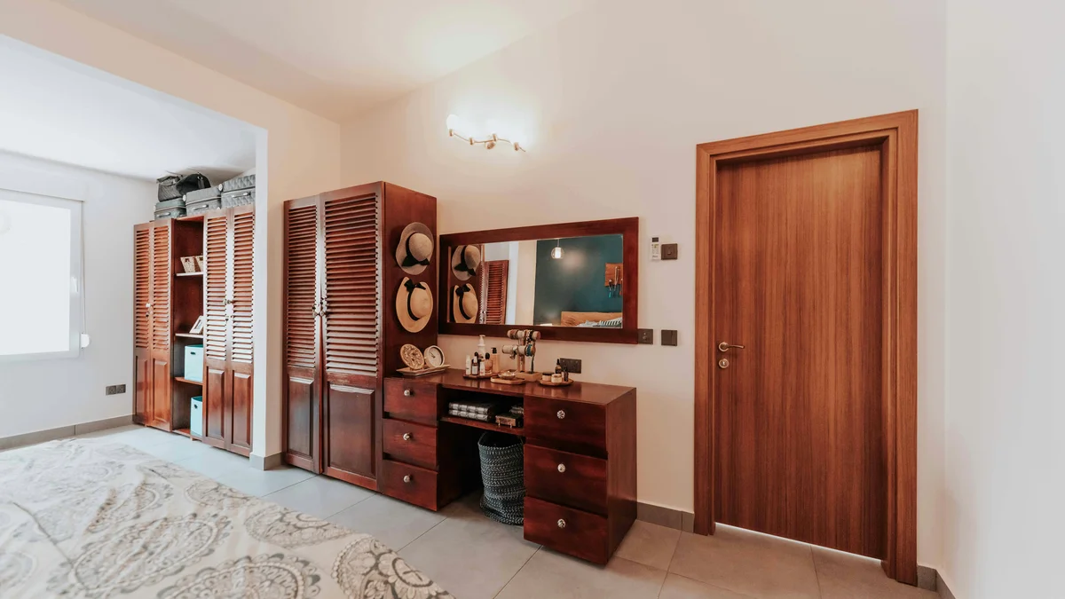 Interior de quarto acolhedor e convidativo, com móveis de madeira elegantes e decoração.
