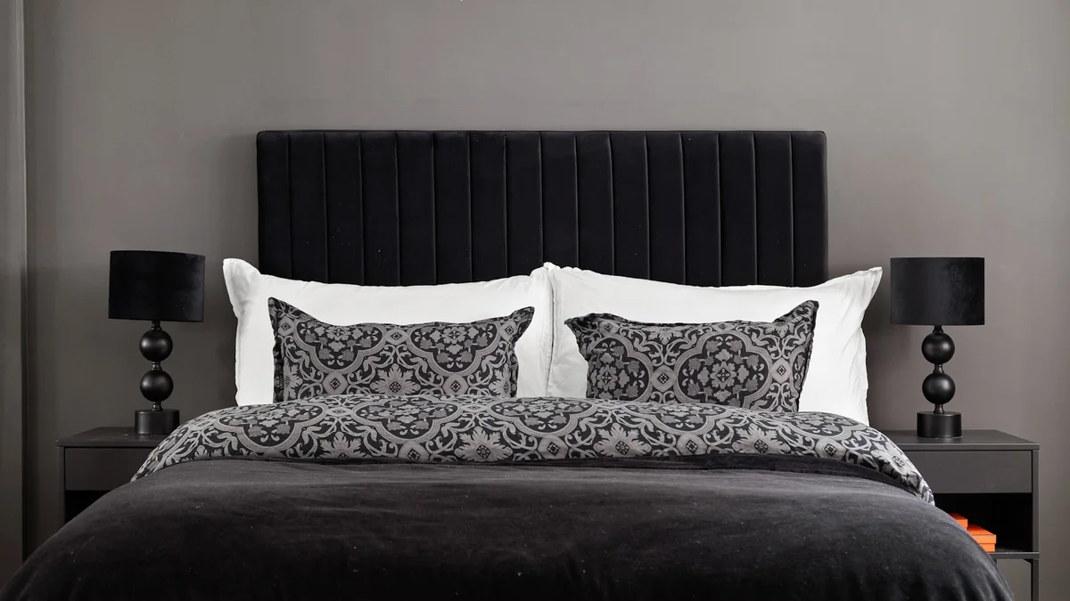 A black and white bedroom with a chandelier Ilustração editorial secção 1 sobre melhor roupa de cama no formato